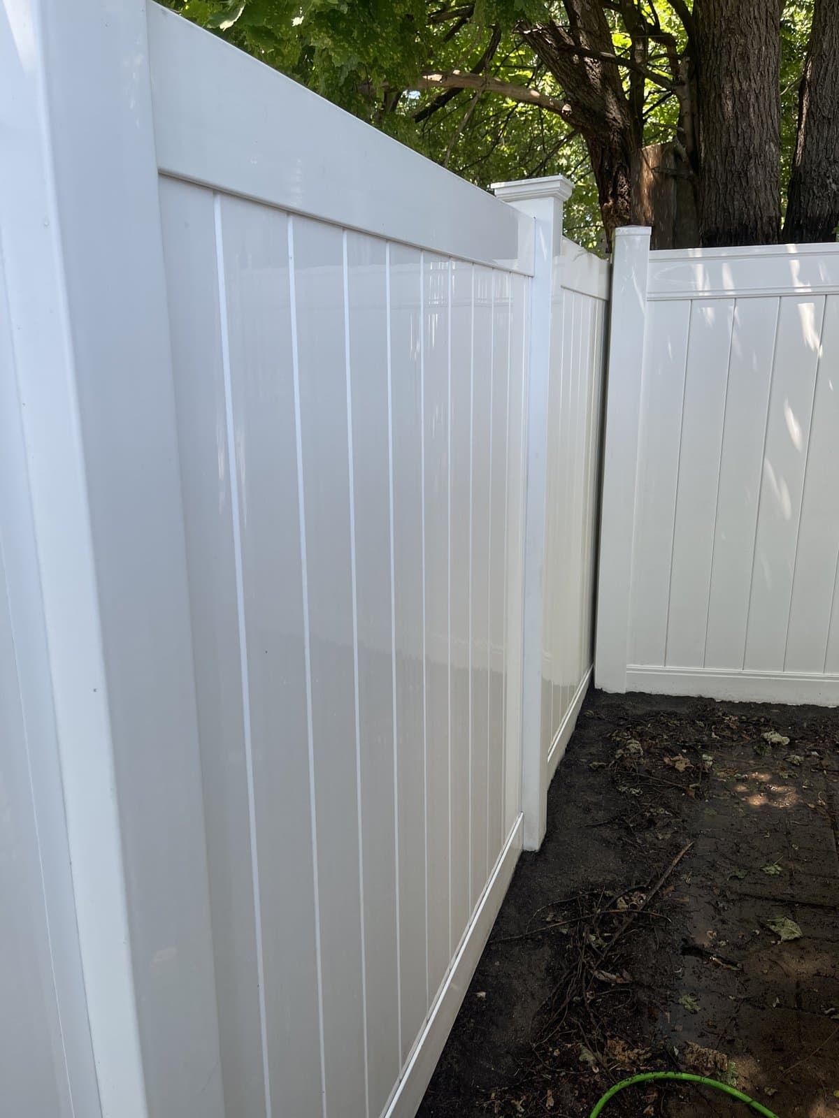 White vinyl fence after pressure washing by Morrison Handyman Services